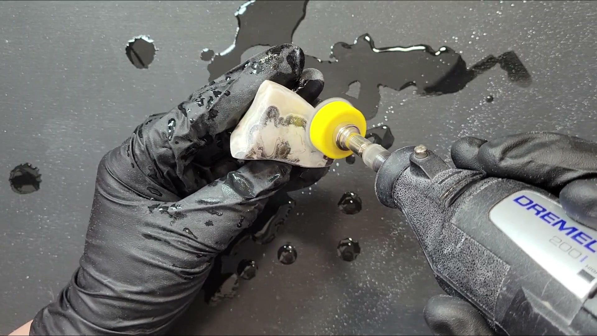 Using a Dremel rotary tool with polishing pad to polish a stone