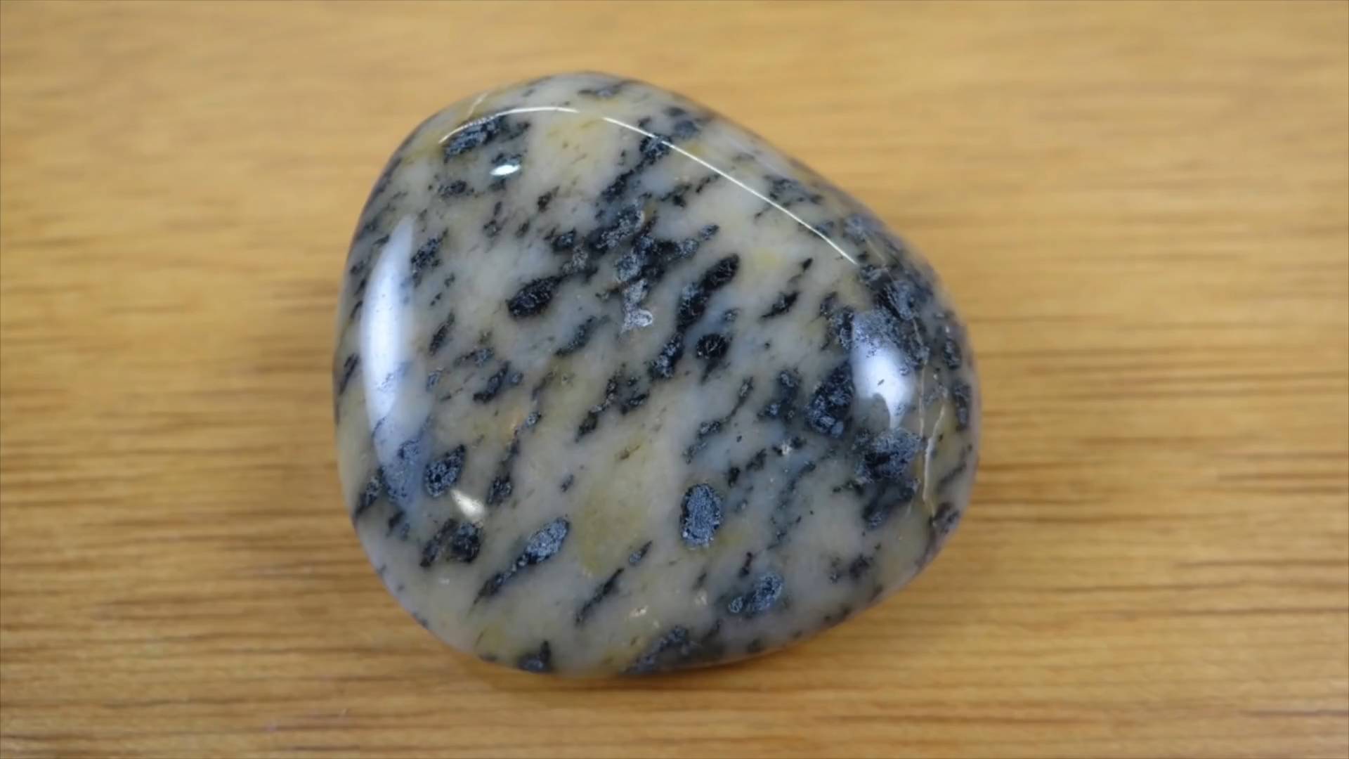 Dark tumbled stone with visible striations
