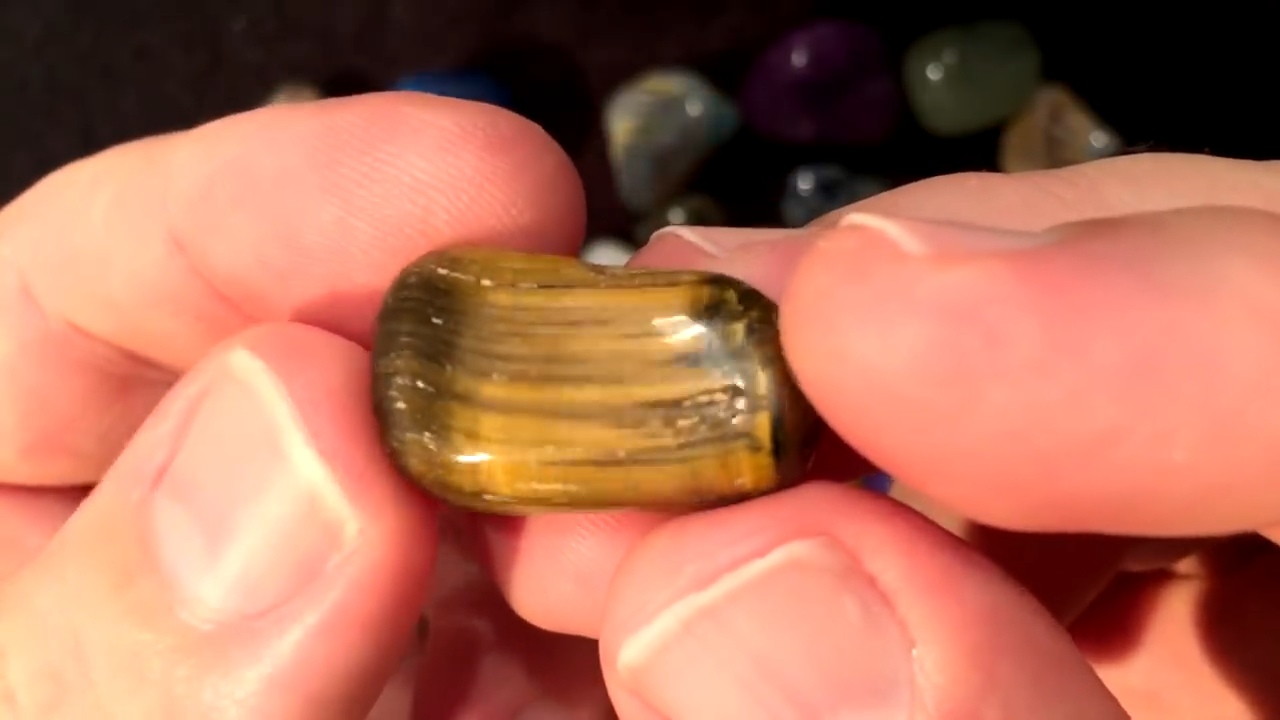 Golden chatoyant tiger's eye tumbled stone