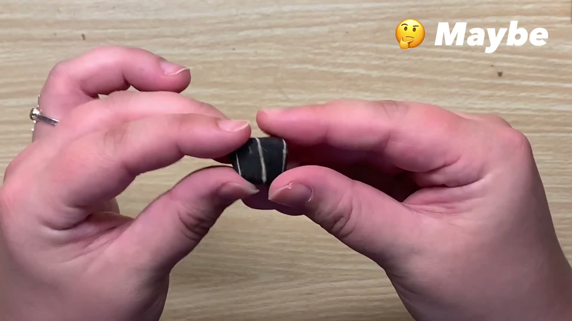 inspecting a tumbled rock between grit stages