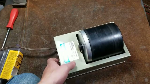 Close-up of the Lortone 3A rock tumbler showing the product label and specifications