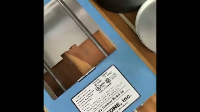 Lortone 3A rock tumbler close-up showing the model label and blue metal housing