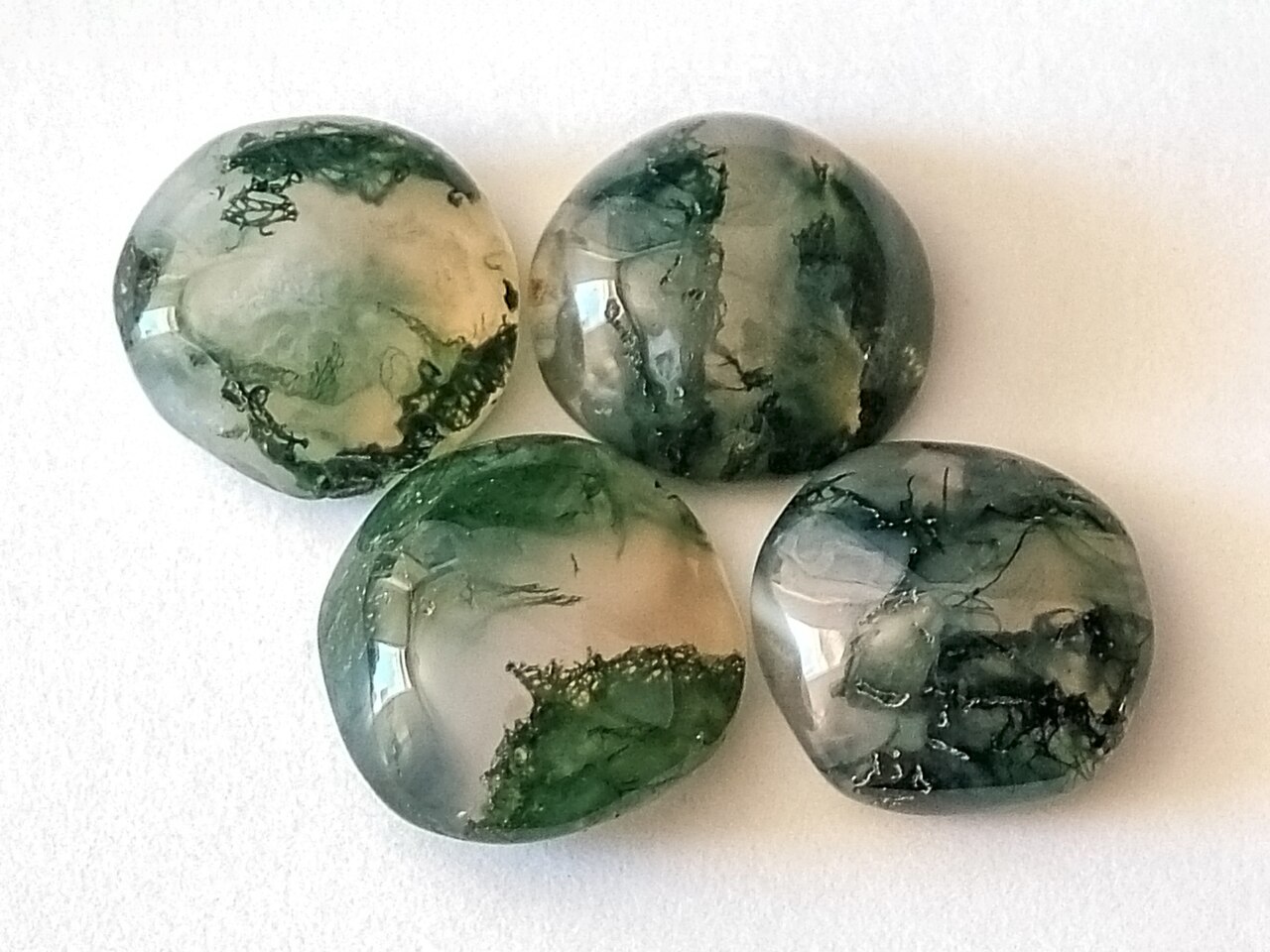 Polished moss agate cabochons with green dendritic inclusions
