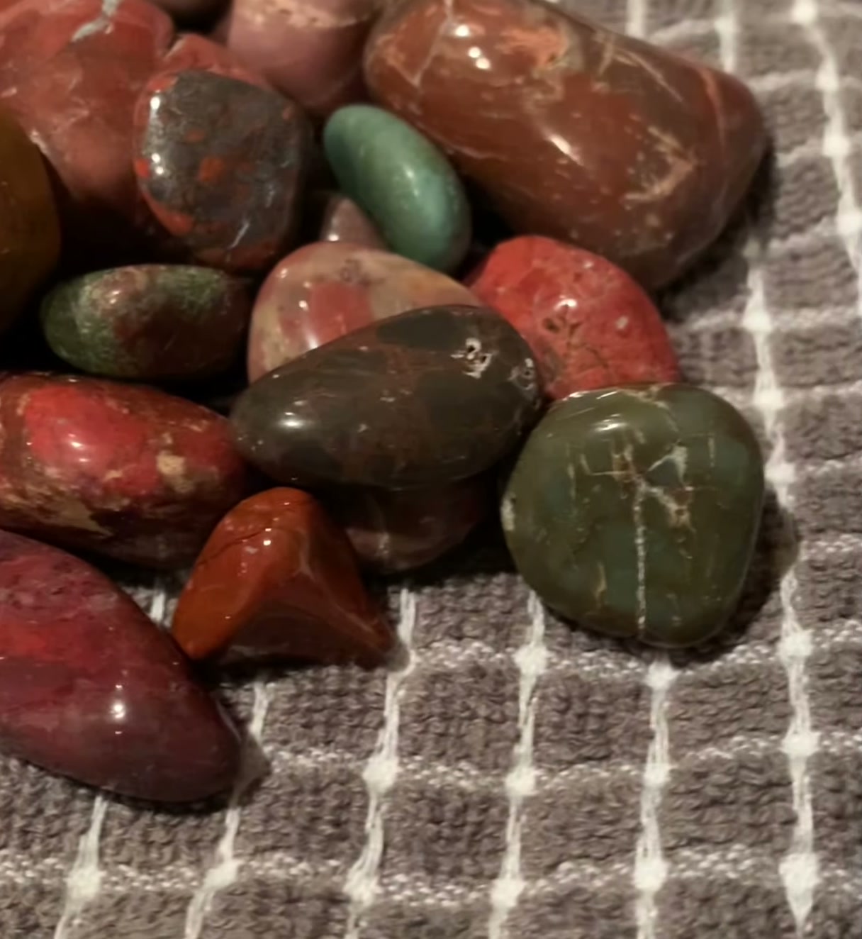 Tumbled stones produced by a National Geographic rock tumbler including jasper, aventurine, and agate