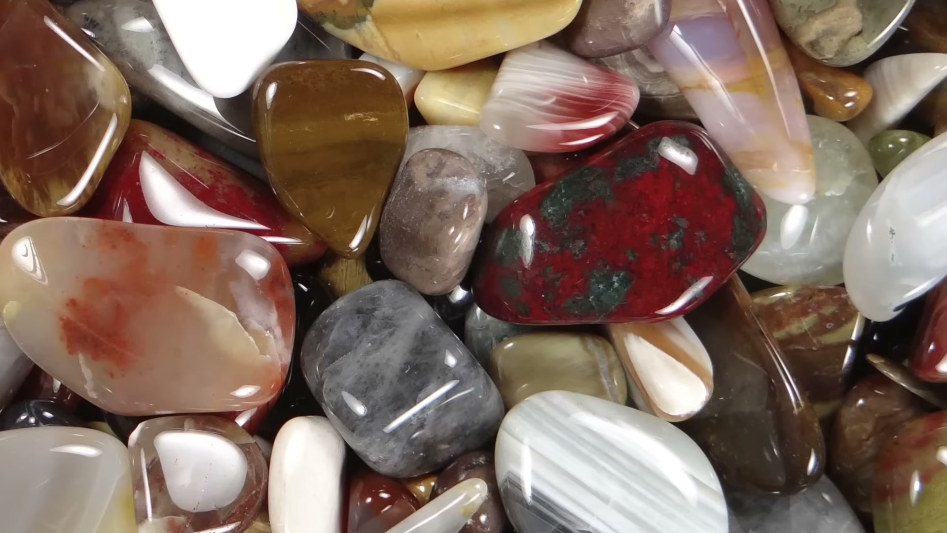 Loading rough rocks into a rock tumbler barrel for polishing