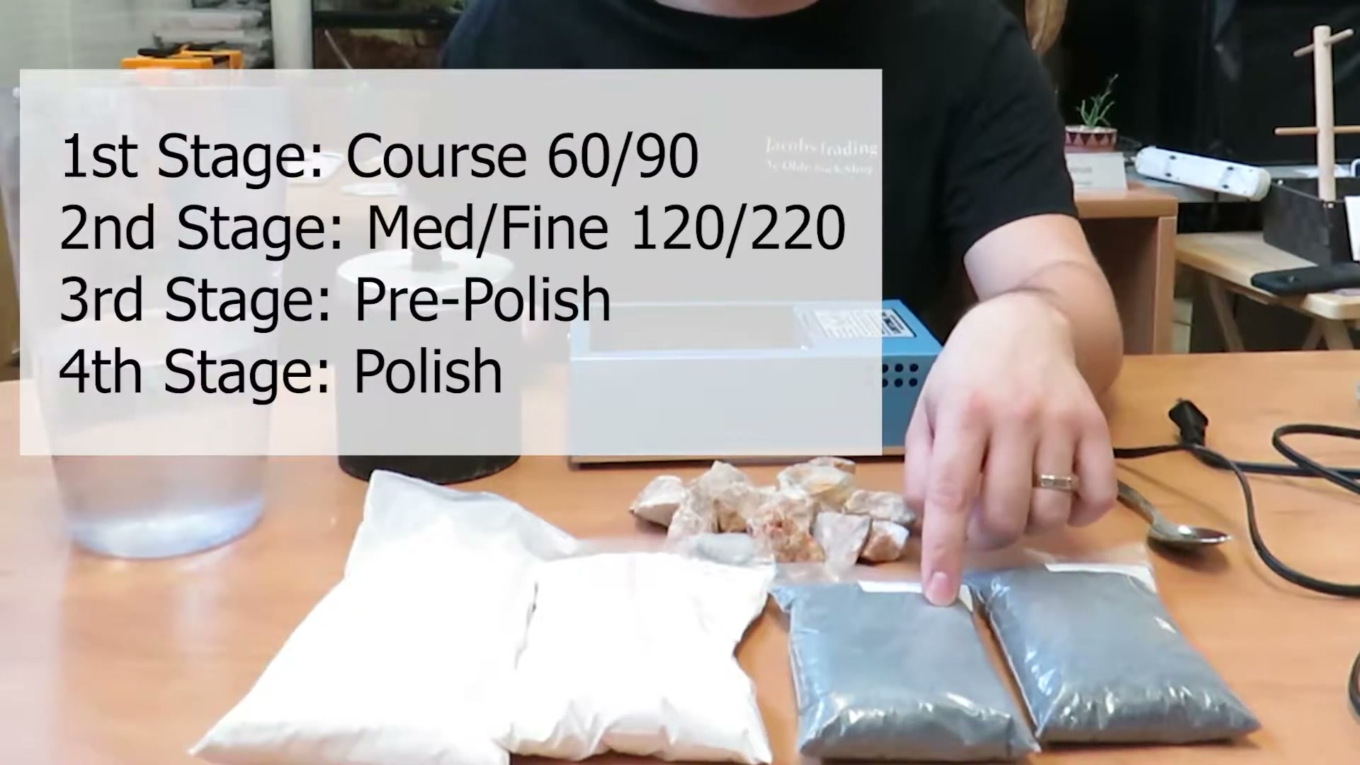 Rock tumbler equipment and supplies laid out on table showing the four stages of tumbling